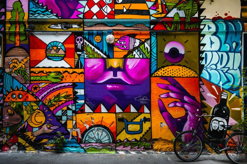Colourful graffiti art on a wall with a bike resting against it